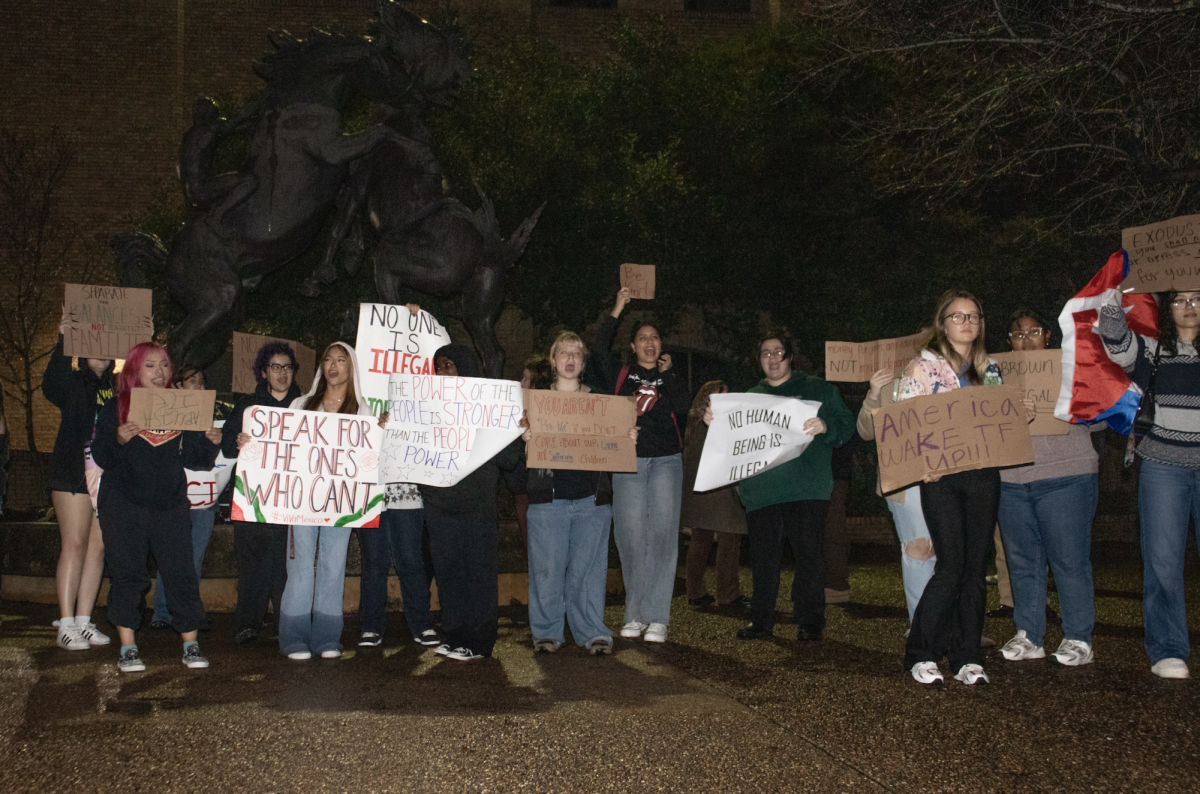 Texas State students hold signs reading slogans such as 'Speak for the ones who can't" at a protest against the nationwide ICE raids Wednesday, Jan. 29 at the Stallions. 